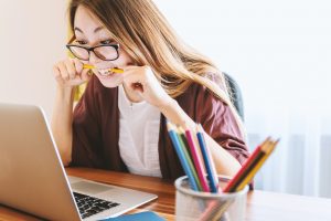 Lady biting pencil